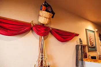 Pirate Suite bedroom with nautical decor and ship wheel