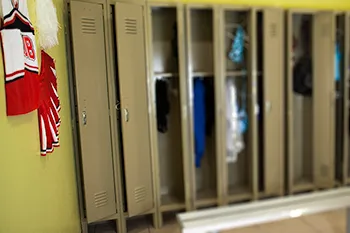 Athletic locker room with cheerleader theme and sex swing